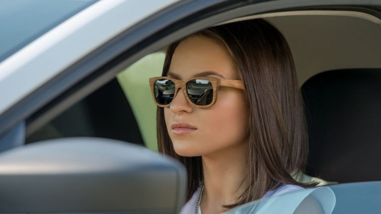 woman wearing sunglasses while driving